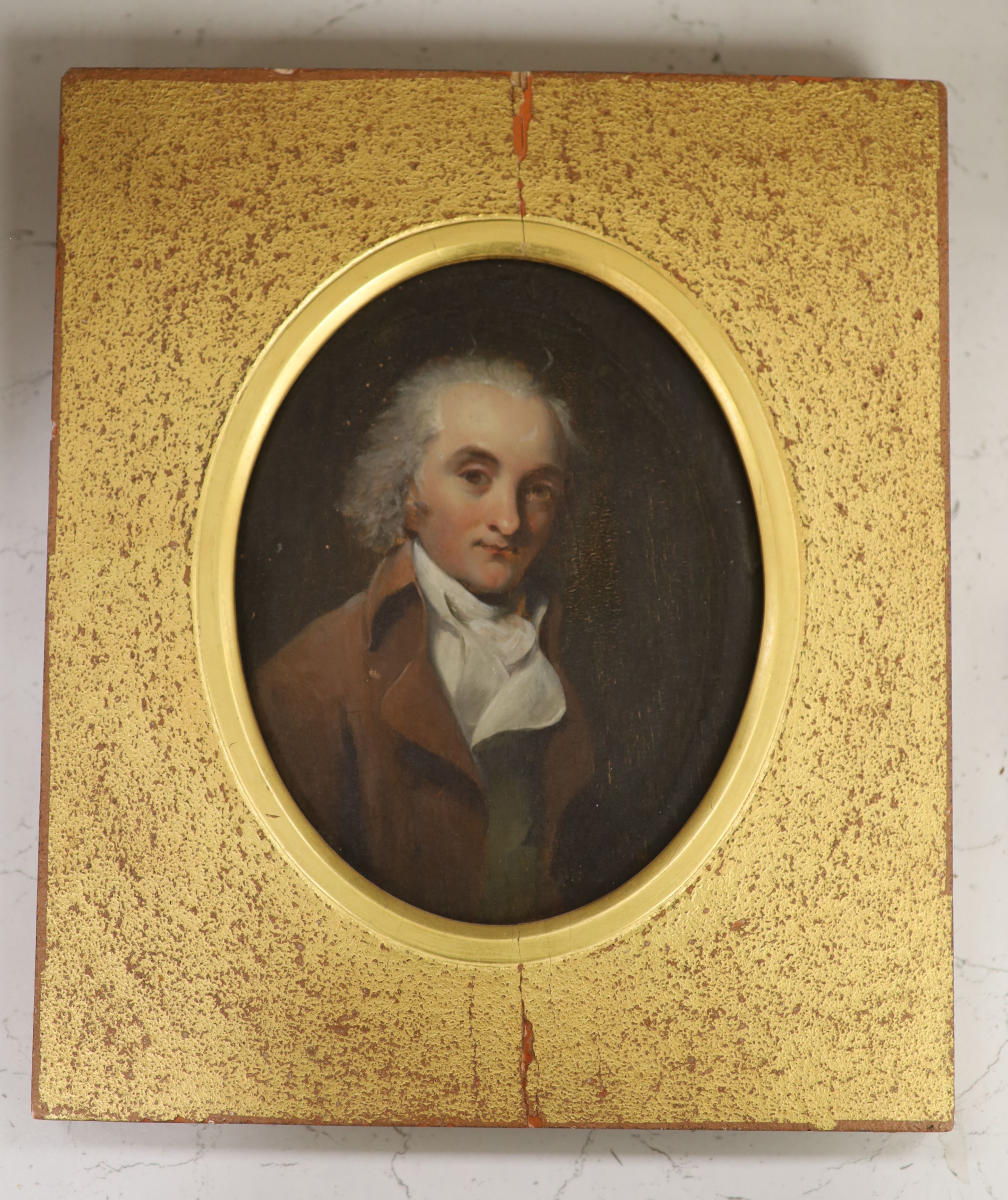 Early 19th century English School, oil on wooden panel, Portrait of a gentleman wearing a brown coat, framed to the oval, 17 x 13.5cm